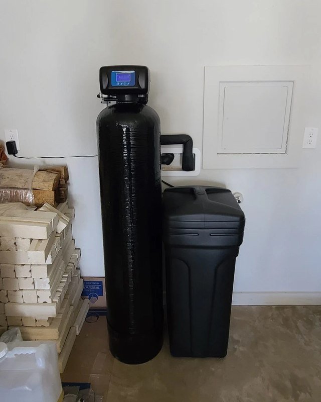 Whole-house water softener and carbon tank installed in a garage